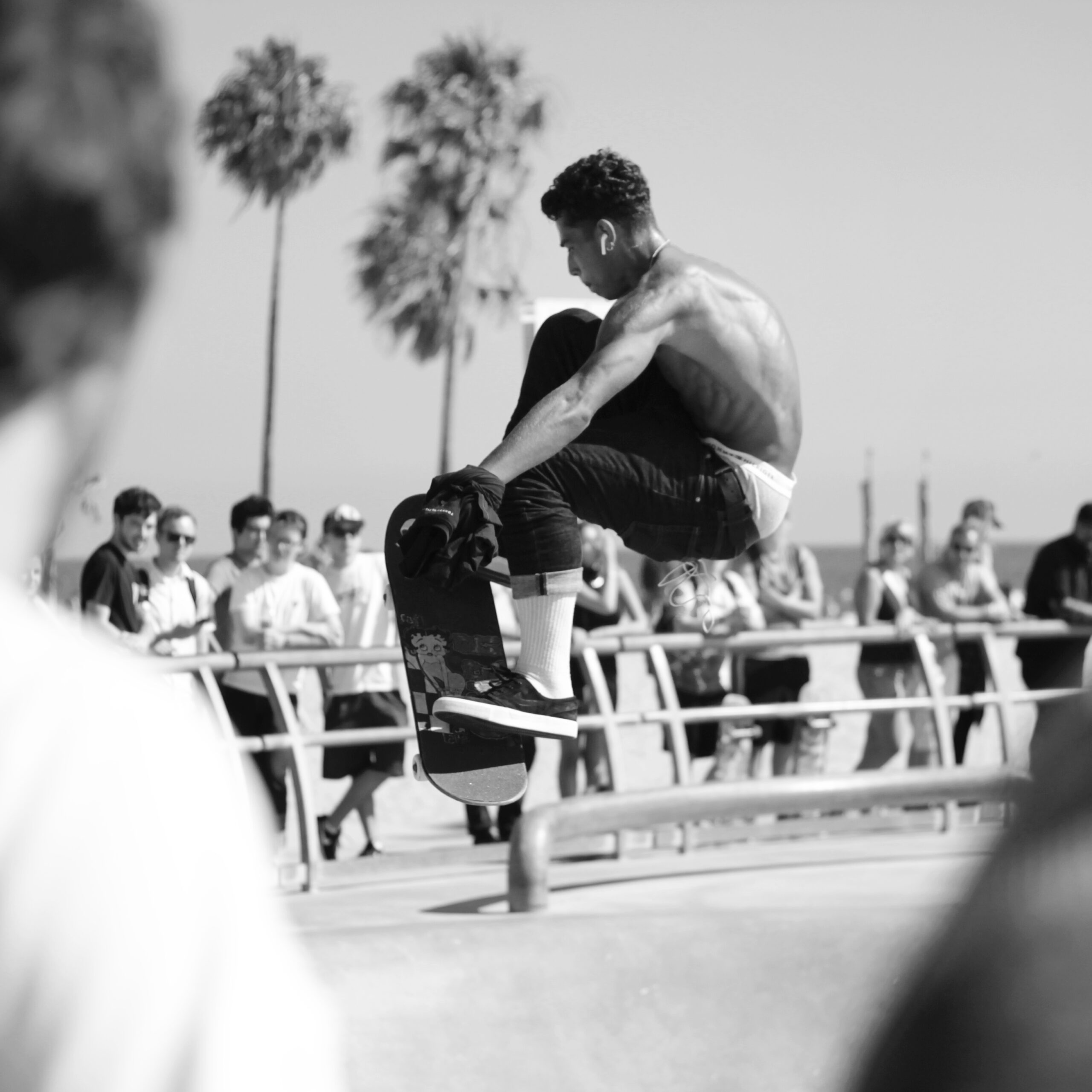 Skater performing a trick off the edge of a pool in the Venice, CA skate park.